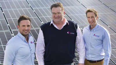 3 men stood in front of solar panels